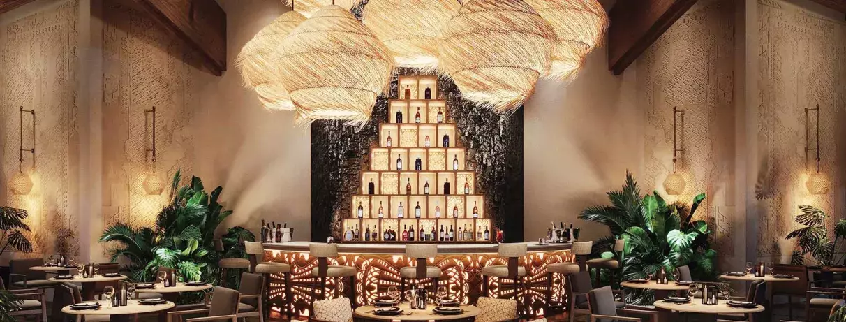 Bar avec comptoir, tables et chaises, ambiance intime, lumière douce