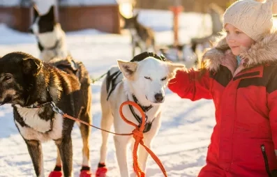 petite fille caressant un chien husky