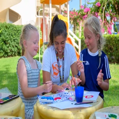 animatrice avec deux enfants, faisant des activités au jardin