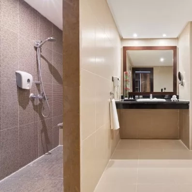 salle de bain avec douche, lavabo et serviette de toilette