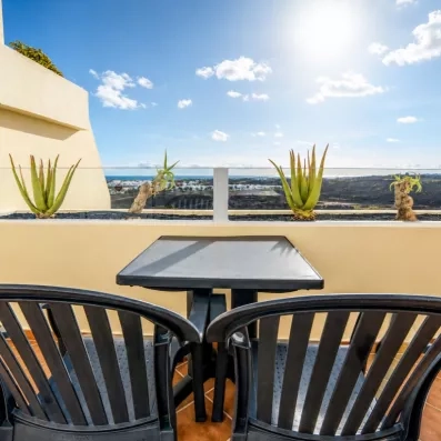 Une terrasse privée avec des chaises de jardin offrant une vue sur l'horizon.