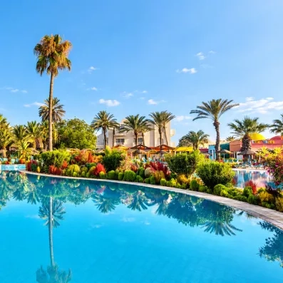 Espace aquatique paysagé entouré de palmiers à hôtel Welcome Meridiana Djerba