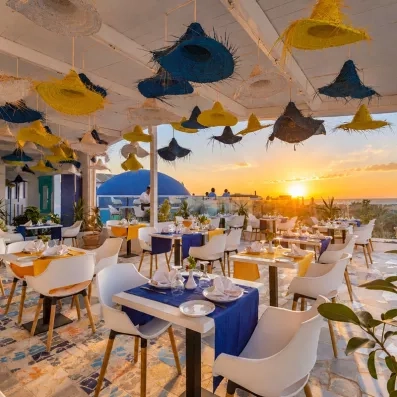 Restaurant panoramique au coucher du soleil avec décoration artisanale à l'hôtel Welcome Meridiana Djerba