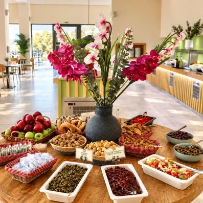 Une table ronde au centre de la salle avec un buffet servie dessus.
