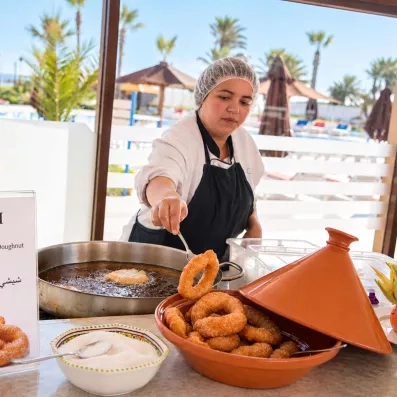 Cuisinière préparant des bambalounis traditionnels au buffet du One Resort Jockey Monastir
