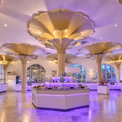 Buffet central du restaurant Mondi Club Shalimar à Hammamet sous des colonnes sculptées en forme de palmiers