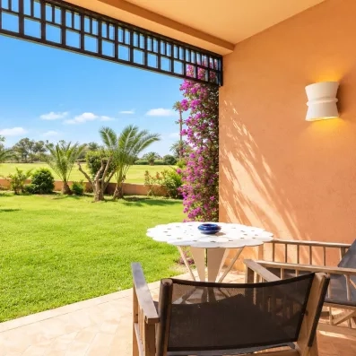 terrasse donnant sur le jardin avec petite table et 2 chaises