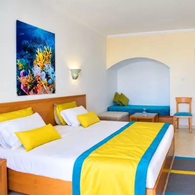 Intérieur d'une chambre familiale au Mondi Club Thalassa Mahdia avec espace salon et banquette