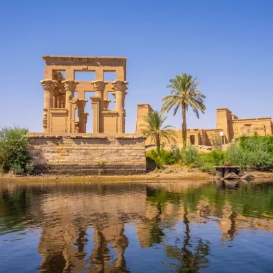 Kiosque de Trajan au temple de Philae se reflétant sur les eaux calmes du Nil, Égypte.