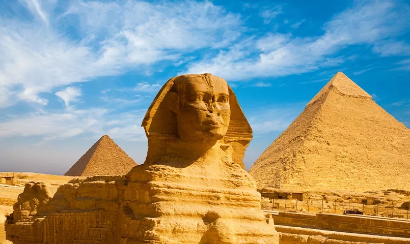 Le Sphinx et les pyramides d'Égypte sous un ciel bleu éclatant. 