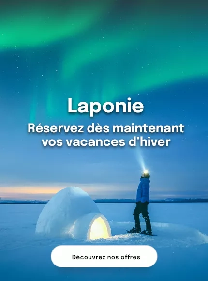 un homme avec une lampe frontale de nuit devant un igloo et une aurore boréale